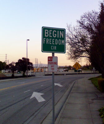 Road sign says "Begin Freedom CIR"