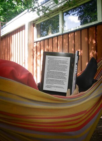 Tomi Nousiainen reading the Finnish Open Life book at his summer cottage